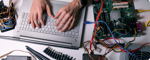 electronics technician working - testing and configuring computer hardware