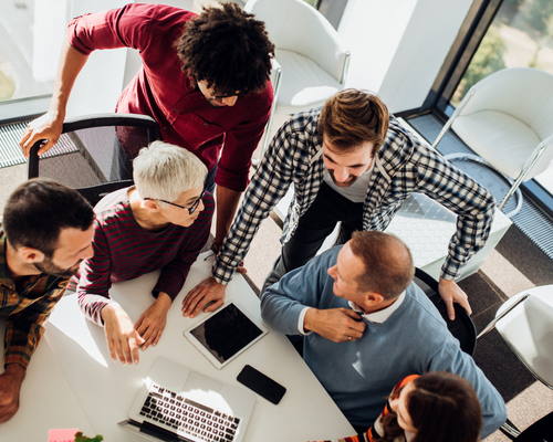 overhead shot of business people collaborating with devices